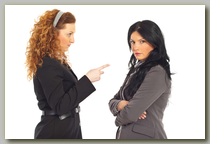 Business woman crossing her arms as her co-worker talks