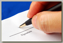 Close-up of an ink pen being used to sign a document