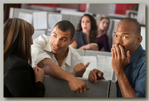 Several office workers reacting to gossip